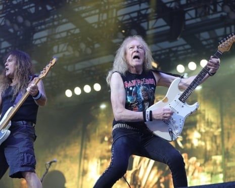 Zwei Metal-Gitarristen spielen unter Bühnenlicht bei einem Konzert